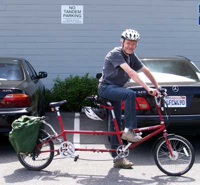 [a picture of me on a tandem bicycle, waiting under a sign  
    'No Tandem Parking']