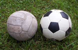 [a brown and a dotted soccer ball]