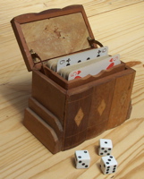 [playing cards in an antique box and a few dice]