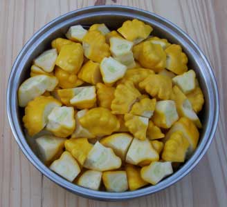 [Yellow Patty Pan Squash, cut and in a steaming basket]