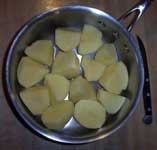 [peeled potatoes in a pot]
